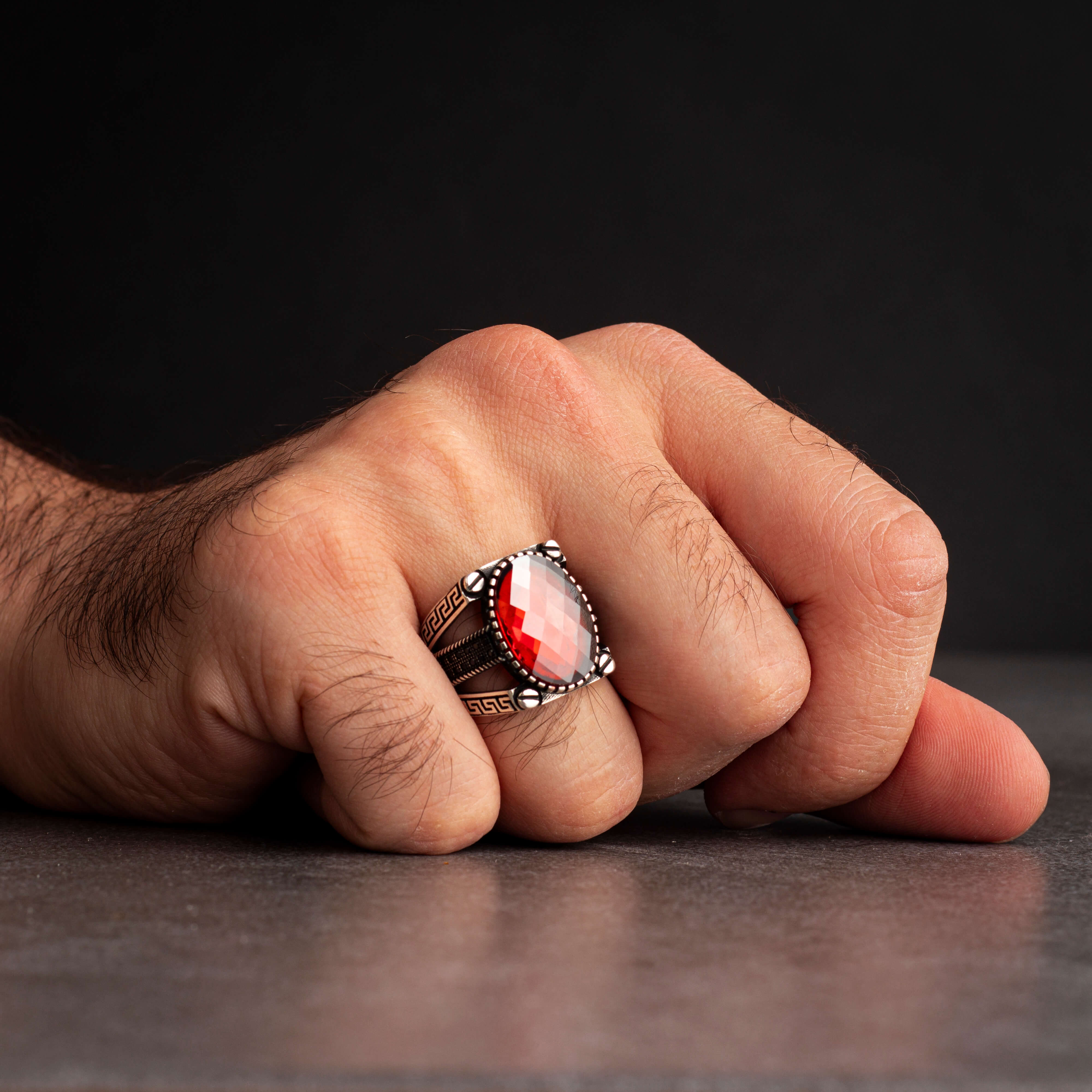 Men's silver ring decorated with red zircon stone