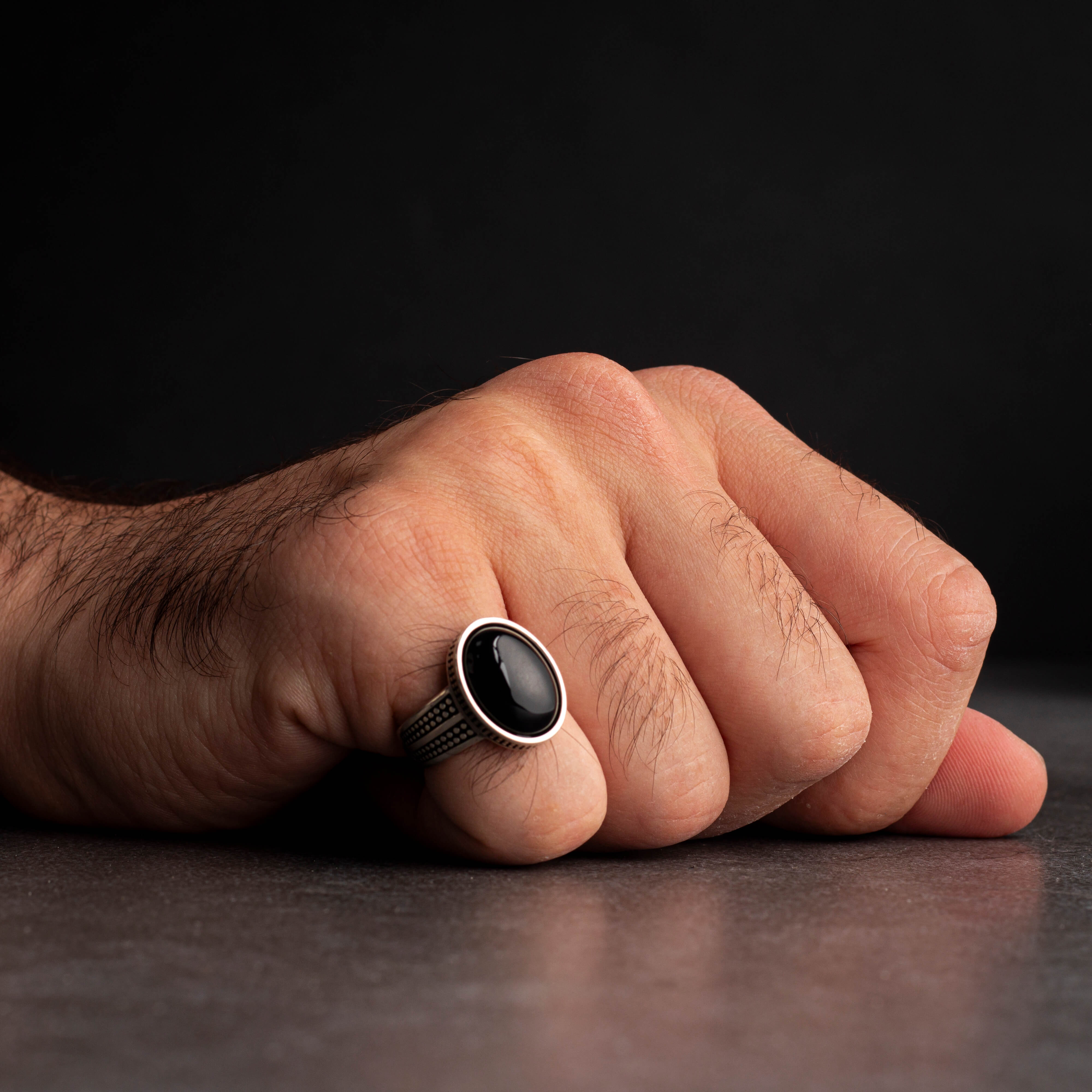Men's silver ring decorated with black onyx stone with circular engravings