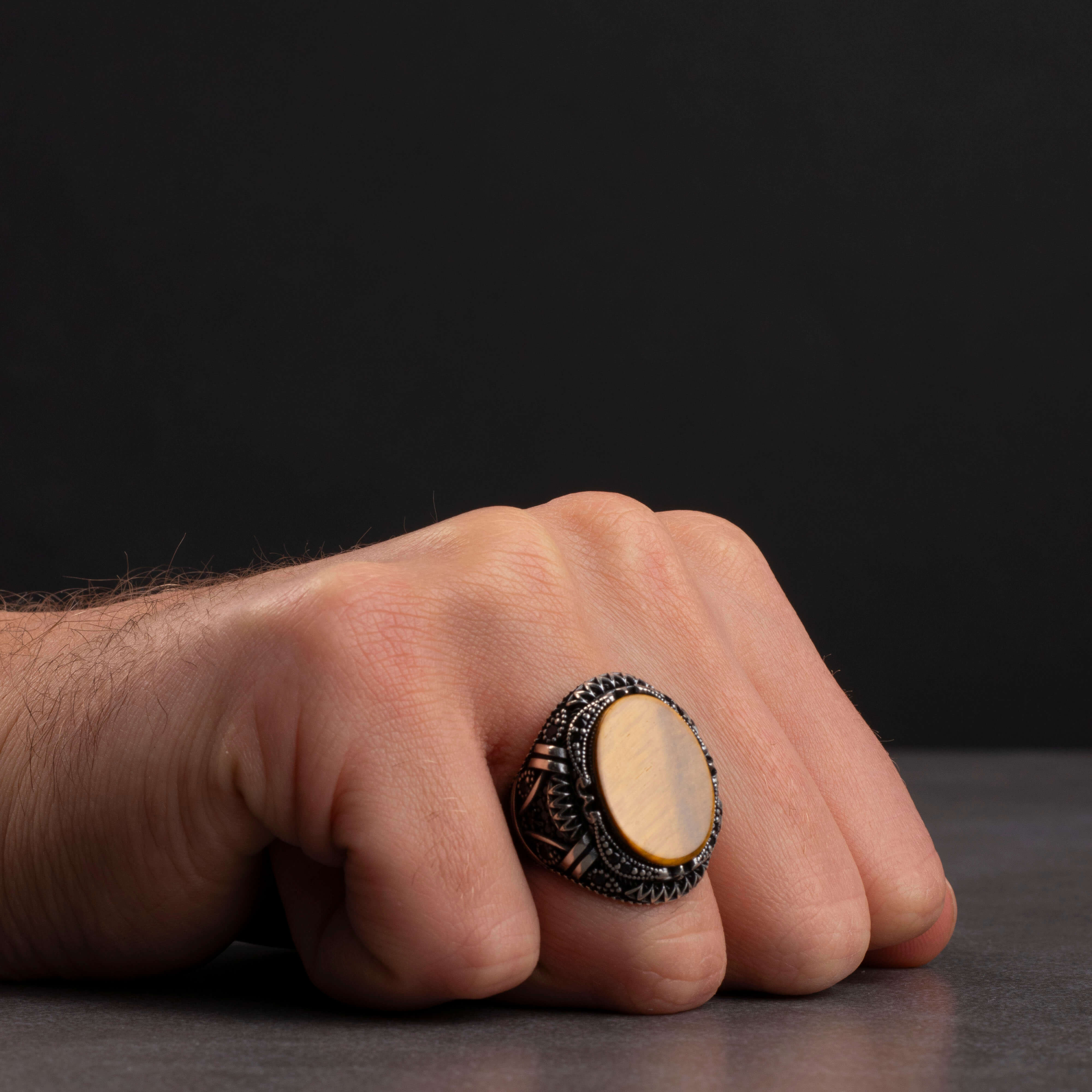 Men's silver ring with tiger's eye stone and prominent geometric details