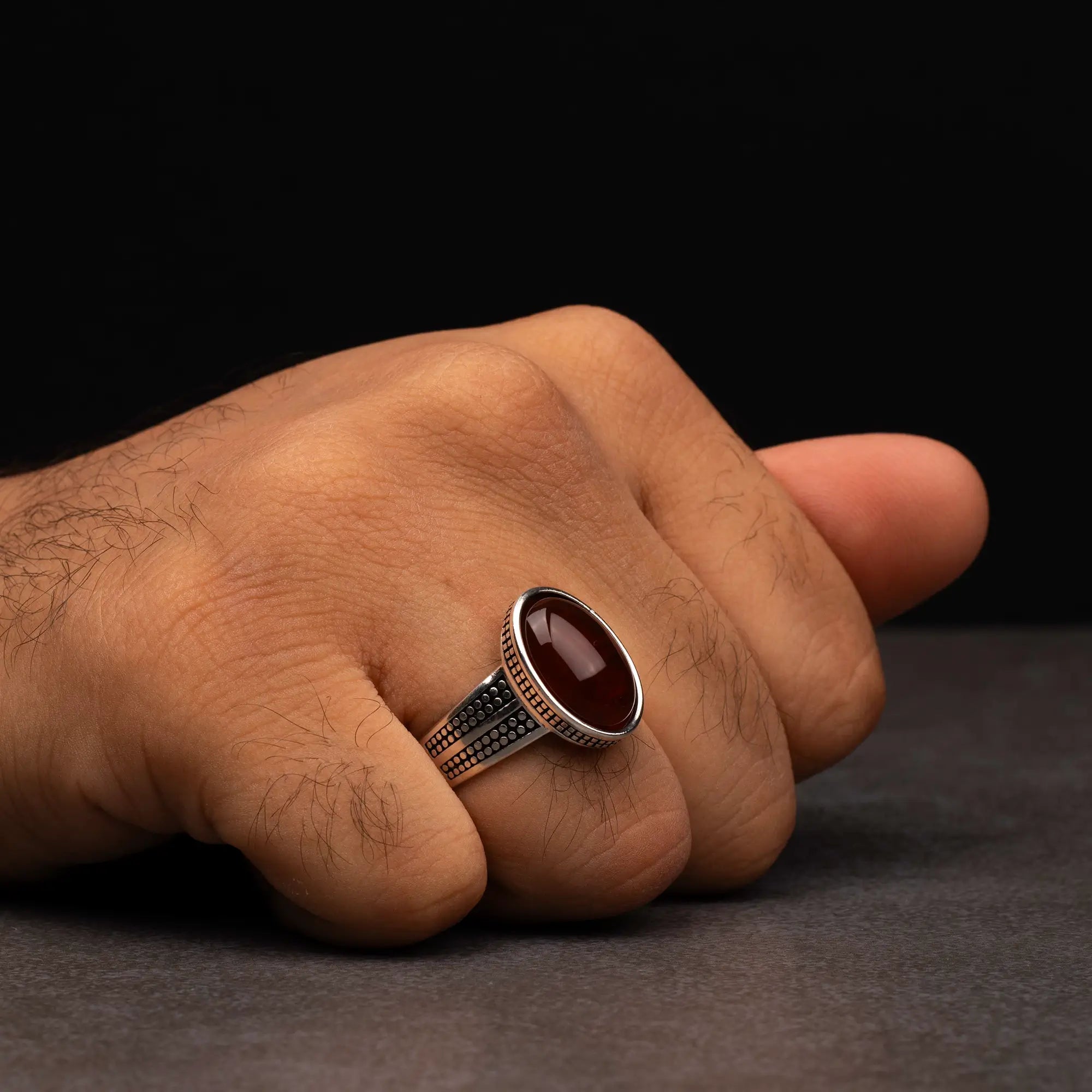 Men's silver ring decorated with a red agate stone with circular engravings