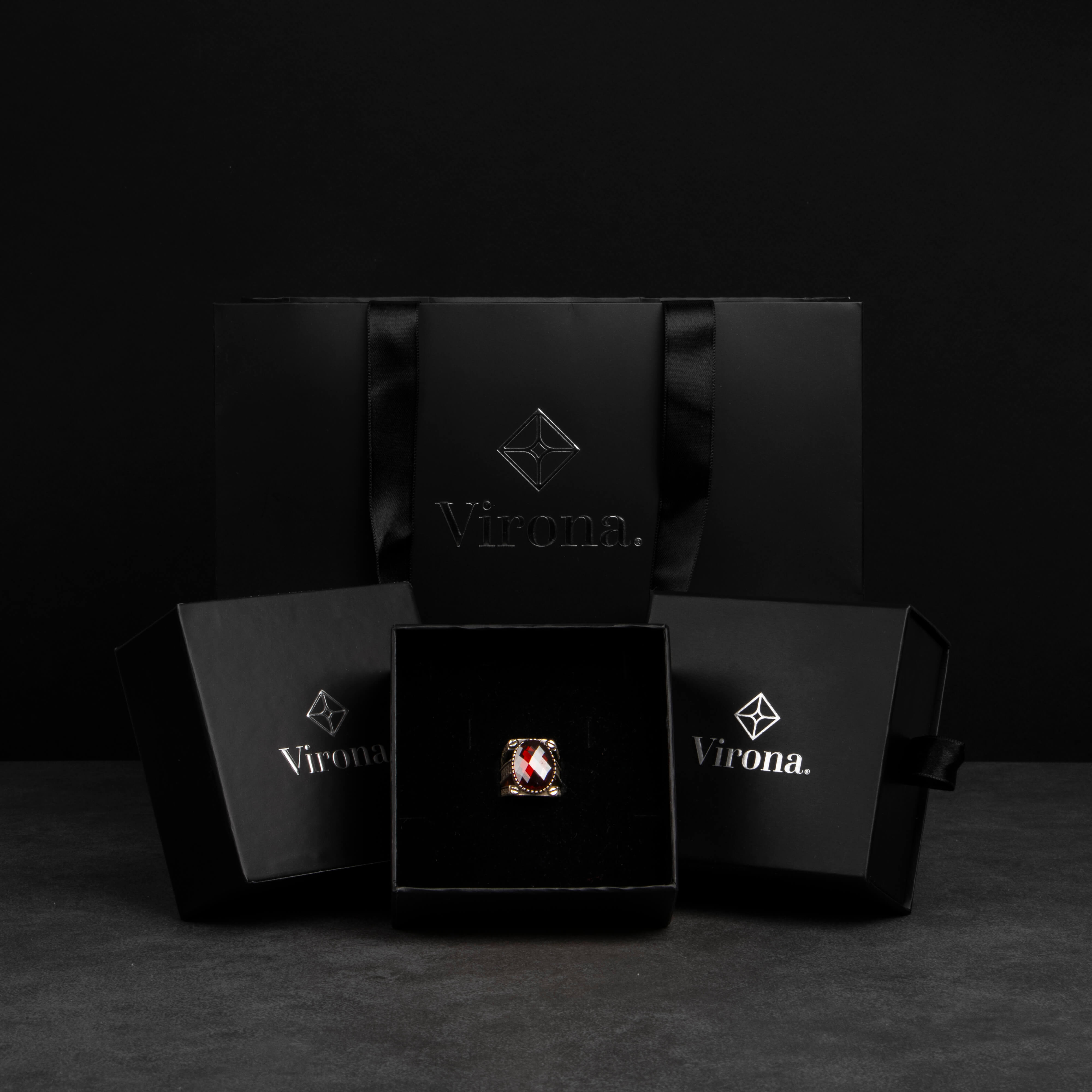 Men's silver ring decorated with red zircon stone