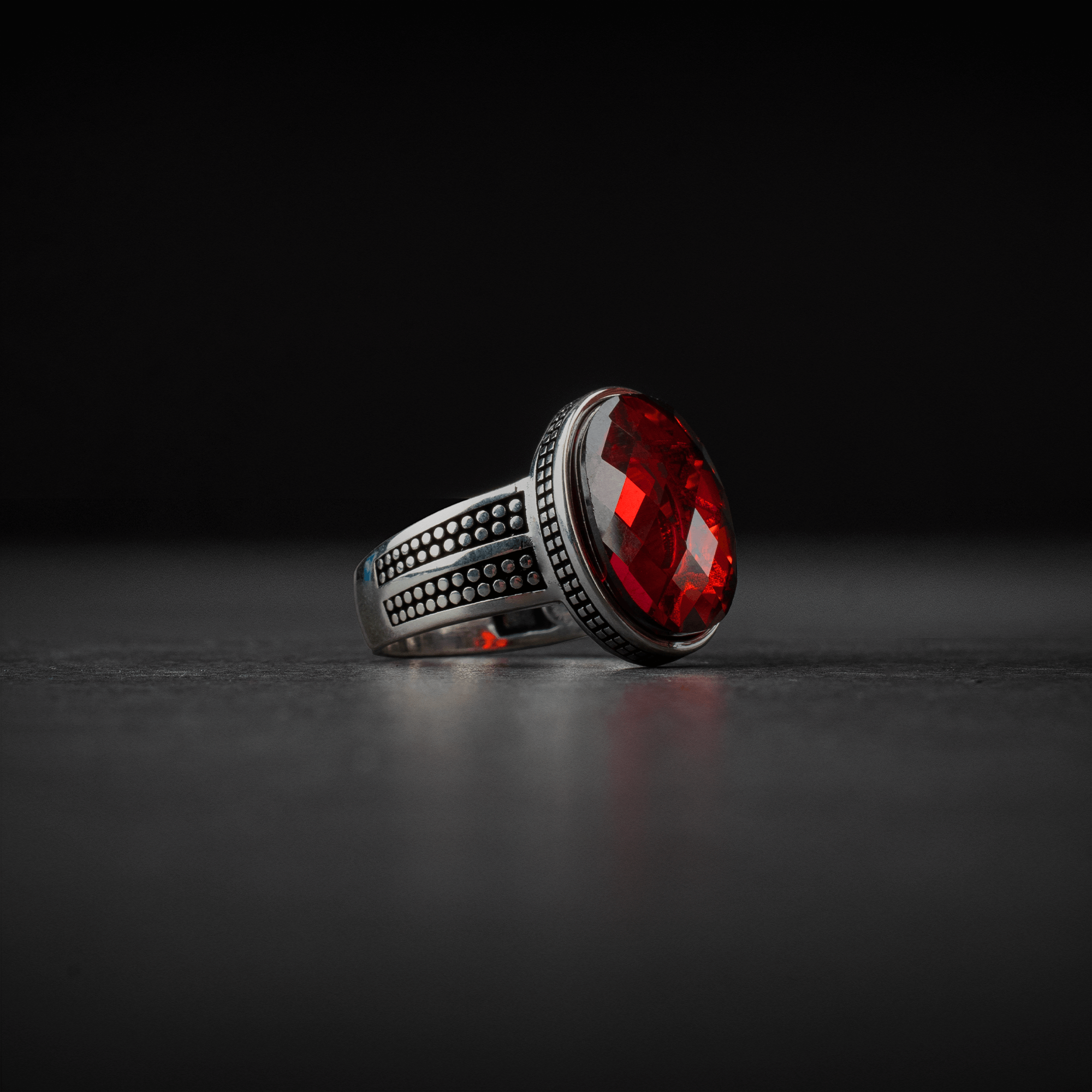 Stylish silver men's ring decorated with red zircon stone