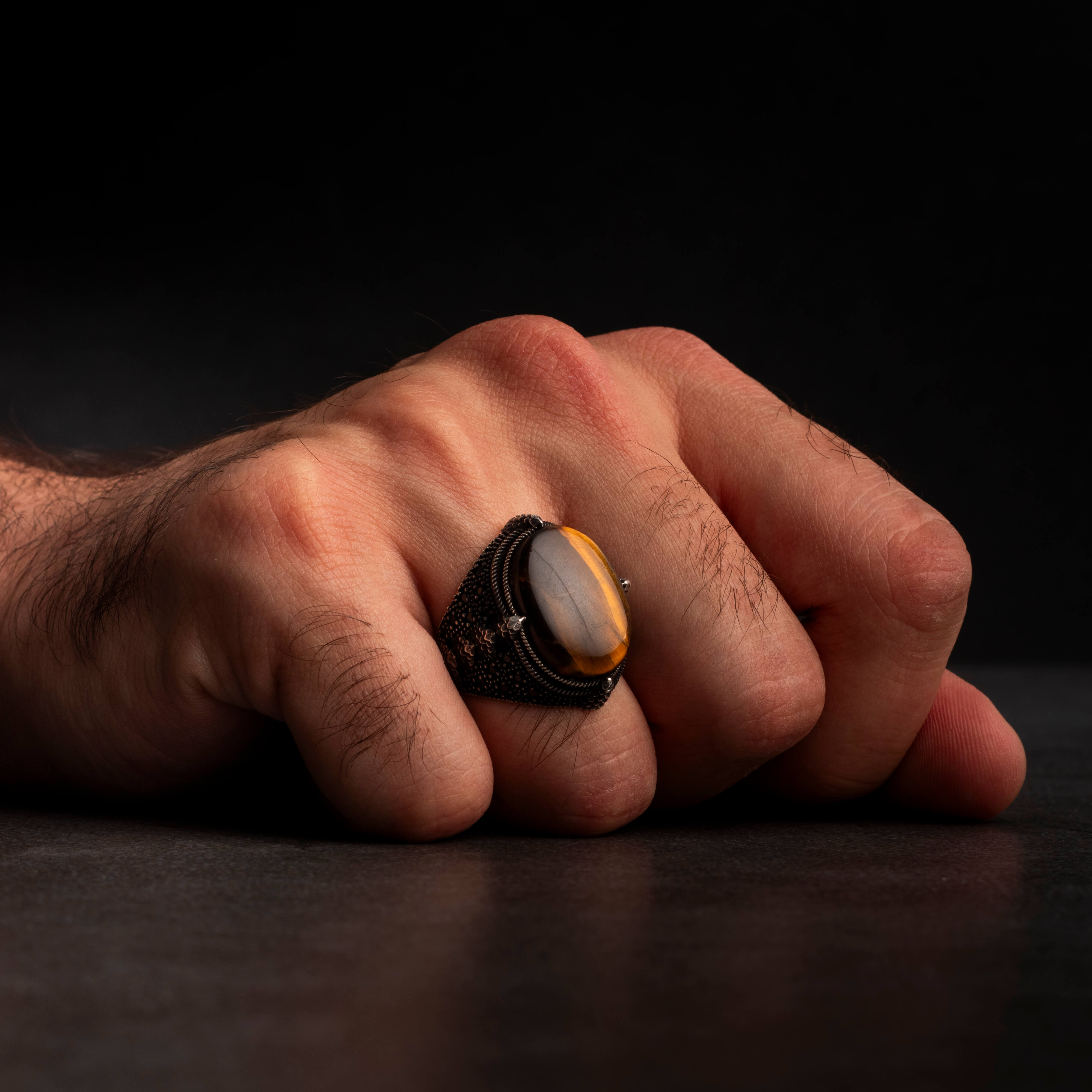 Men's silver ring decorated with a tiger's eye stone
