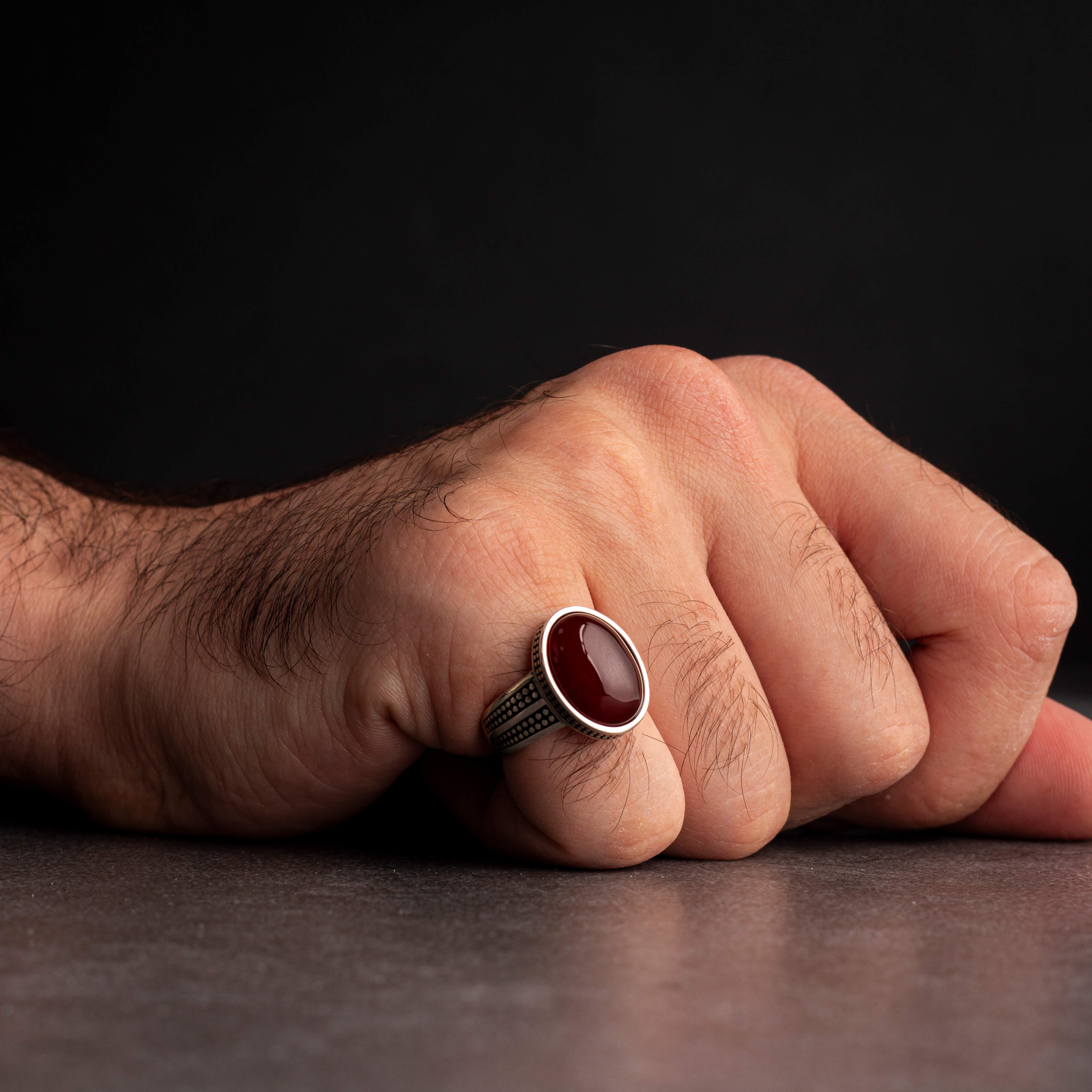 Men's silver ring decorated with a red agate stone with circular engravings